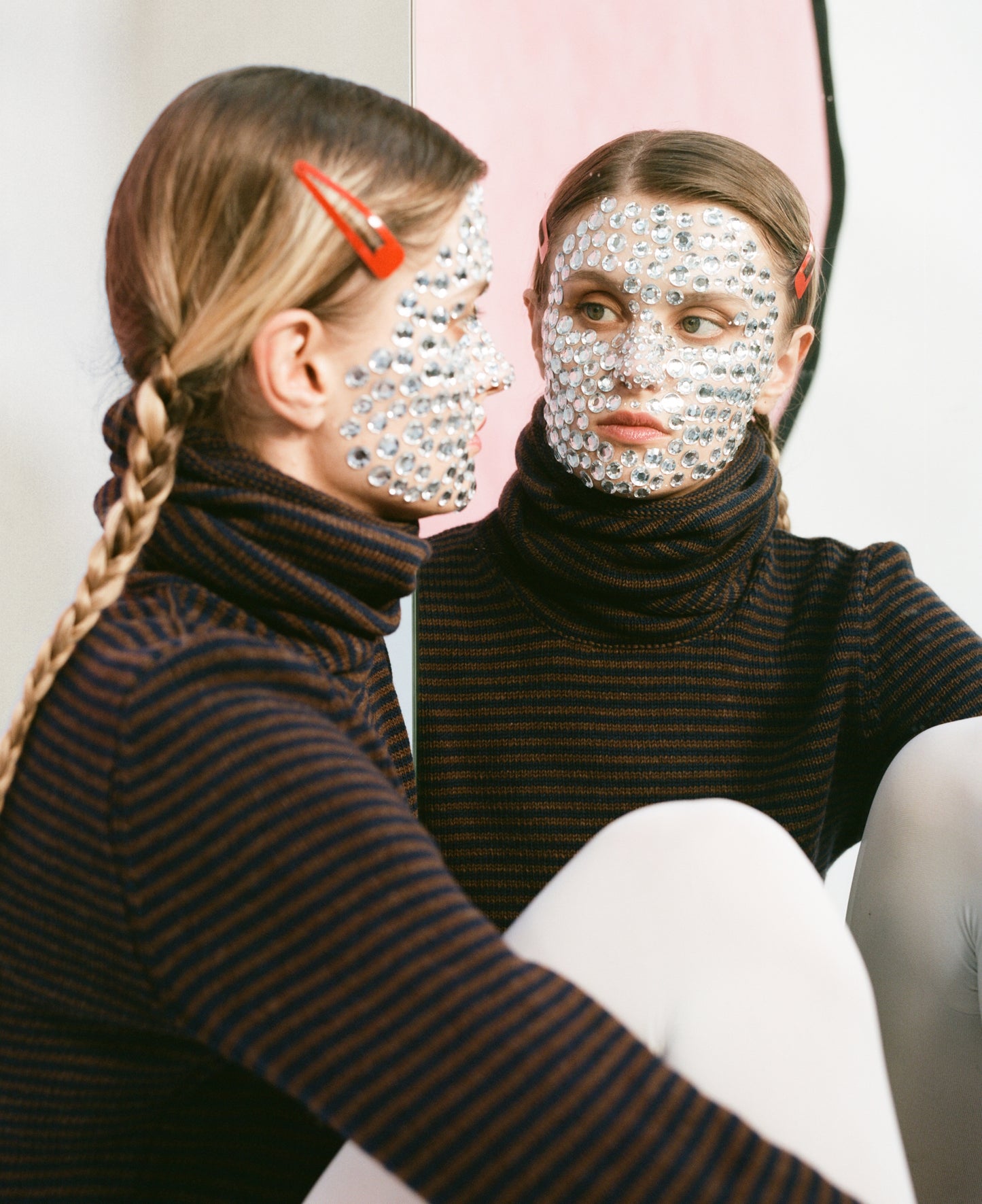 Close up of model wearing stripy snood top in navy & brown