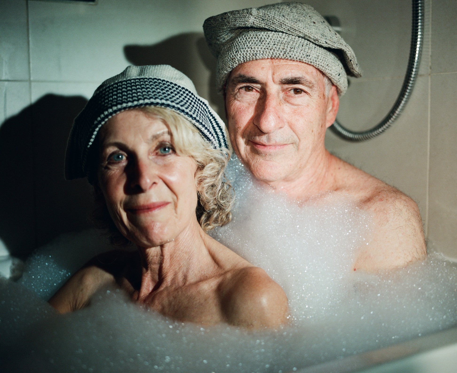 Models wearing  Sack hat in pale grey and  flap hat