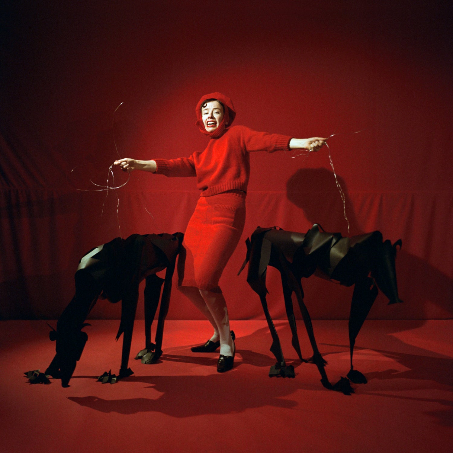 Model posing for the Cast-On 2 Photo Series wearing full red outfit