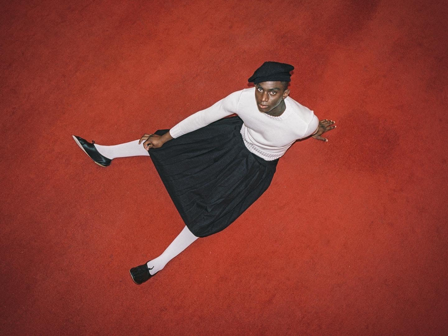 Model wearing black and white outfit, including Sack hat in black