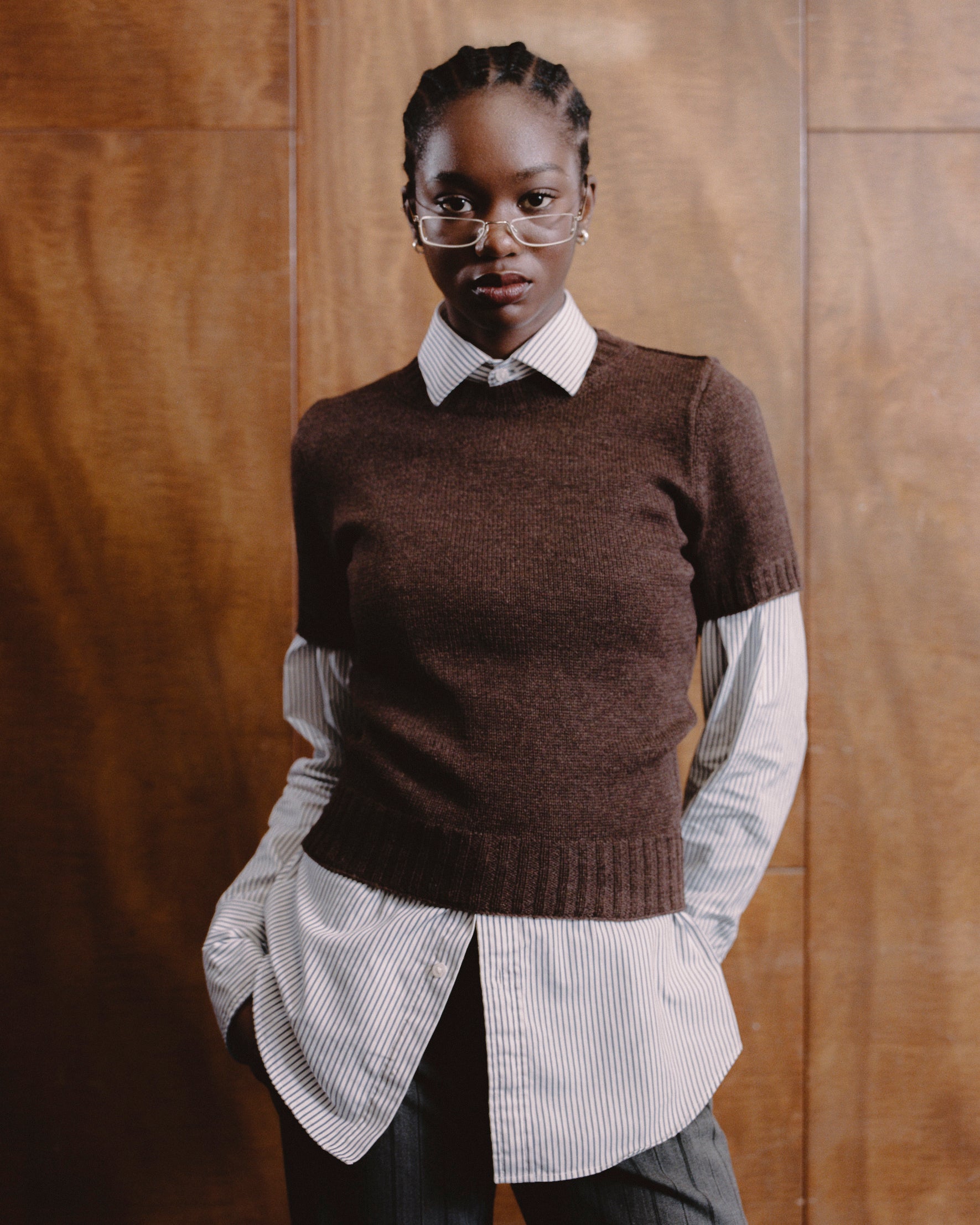 Model wearing t-shirt sweater in chocolate brown over a long sleeve white shirt