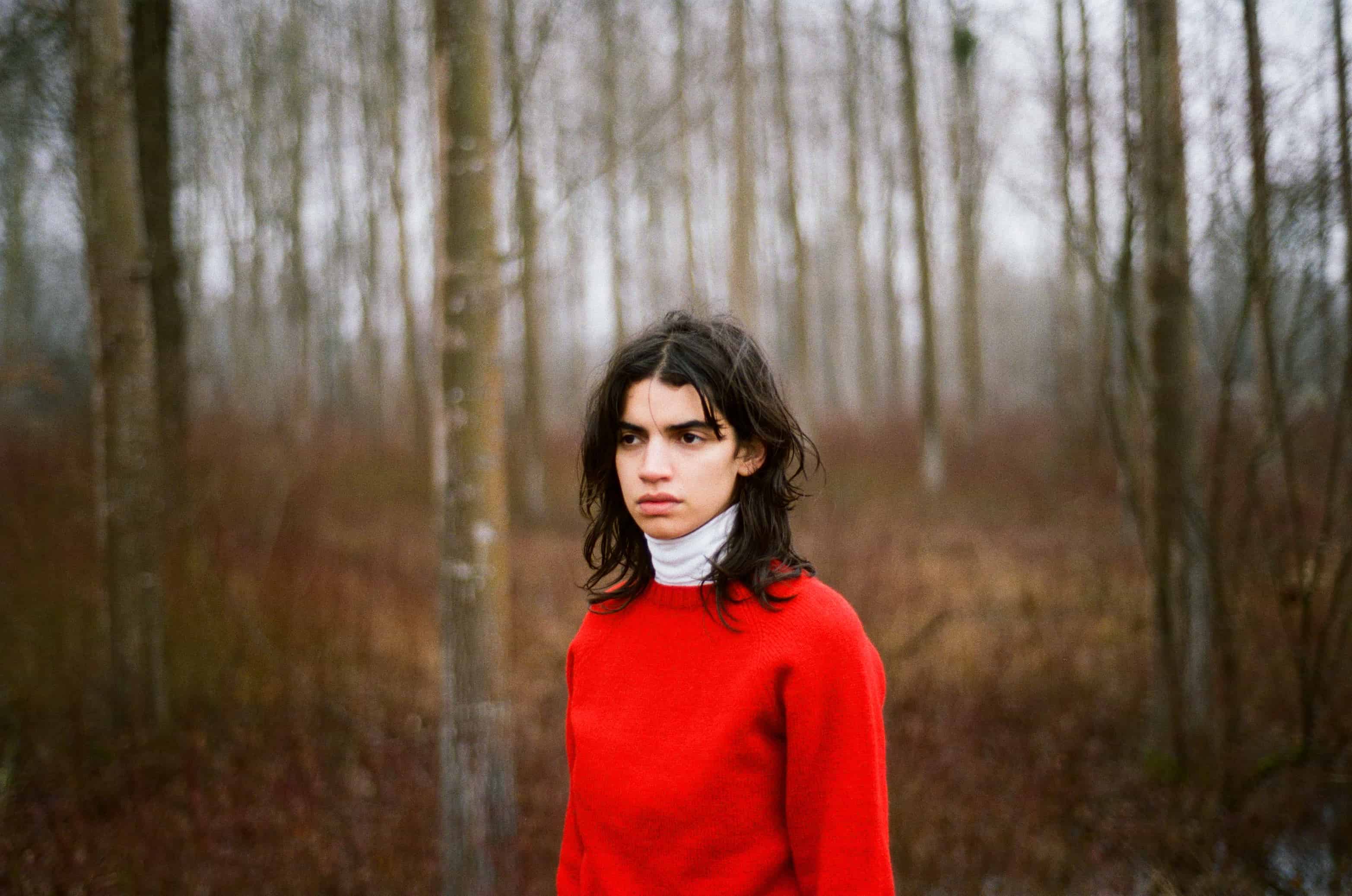 Model wearing red jumper and white turtleneck top