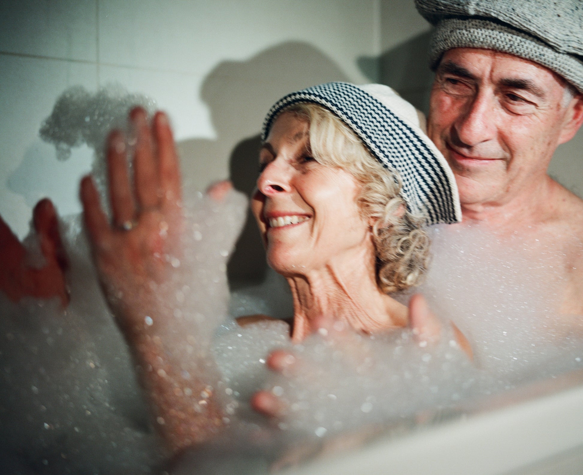 Models wearing  Sack hat in pale grey and  flap hat