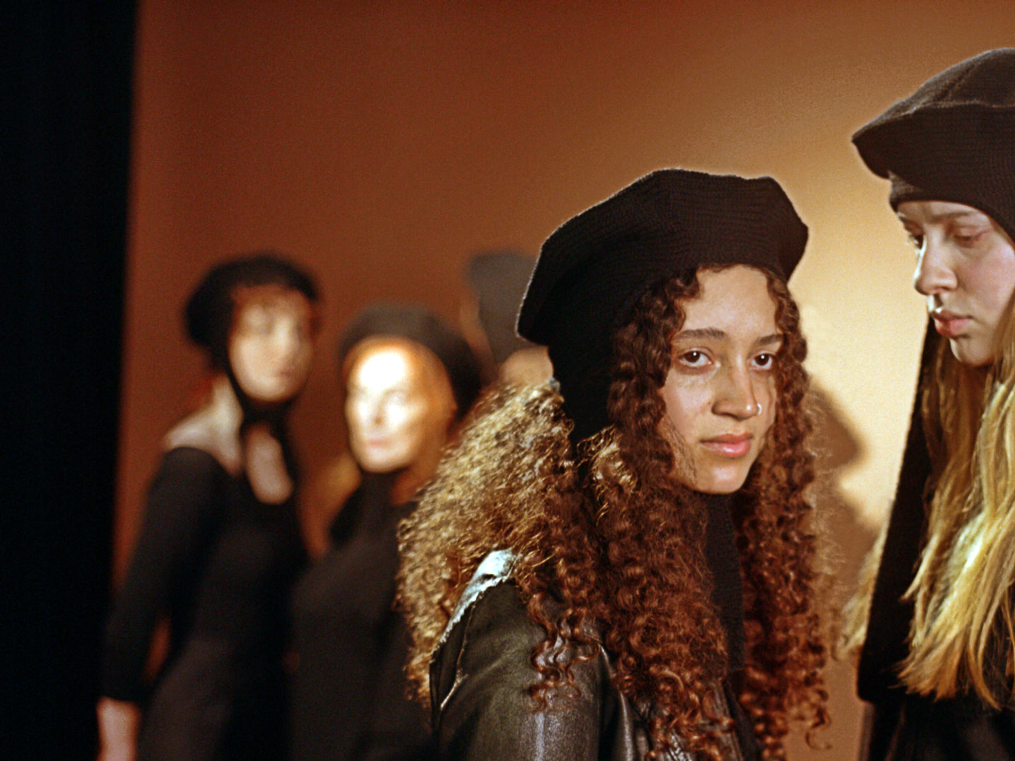 Two models wearing the classic hat in black