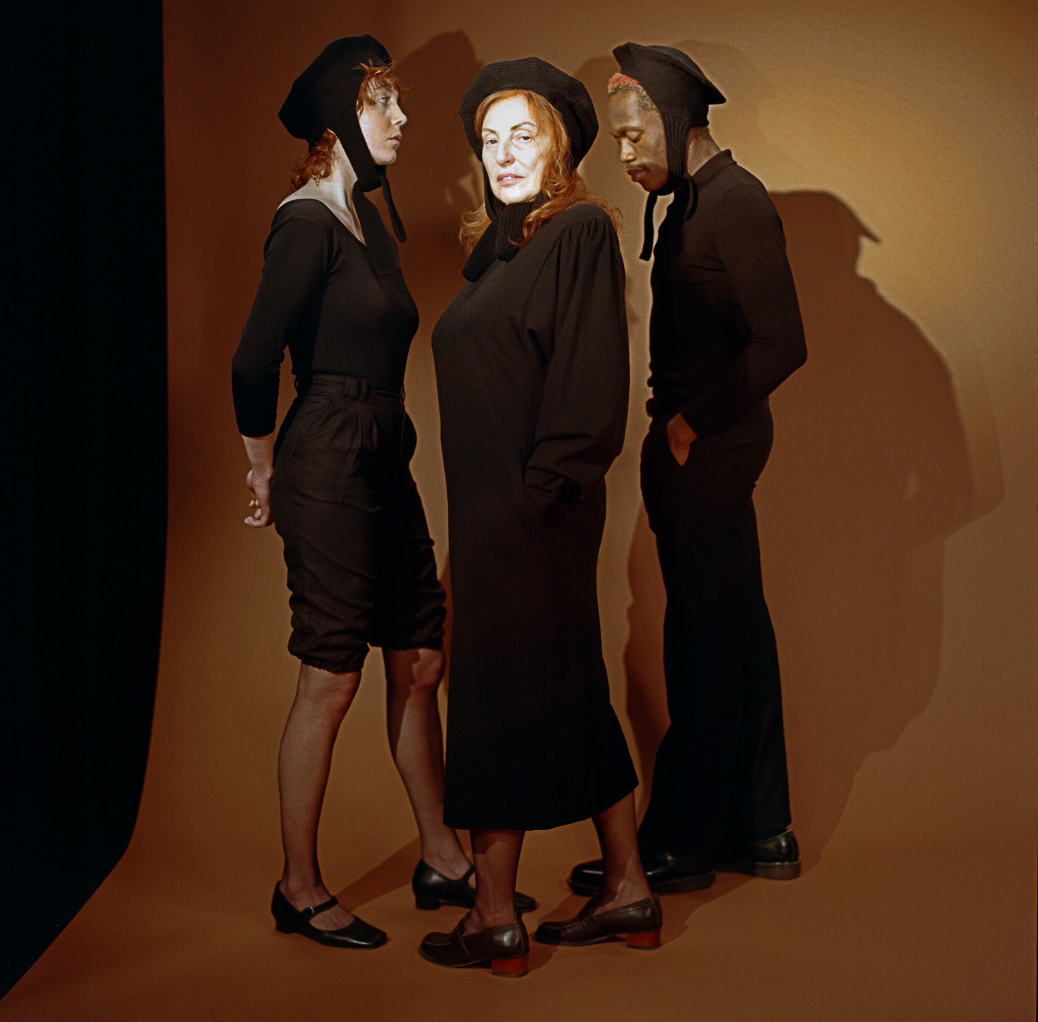 Group photo of models posing wearing classic hats in black
