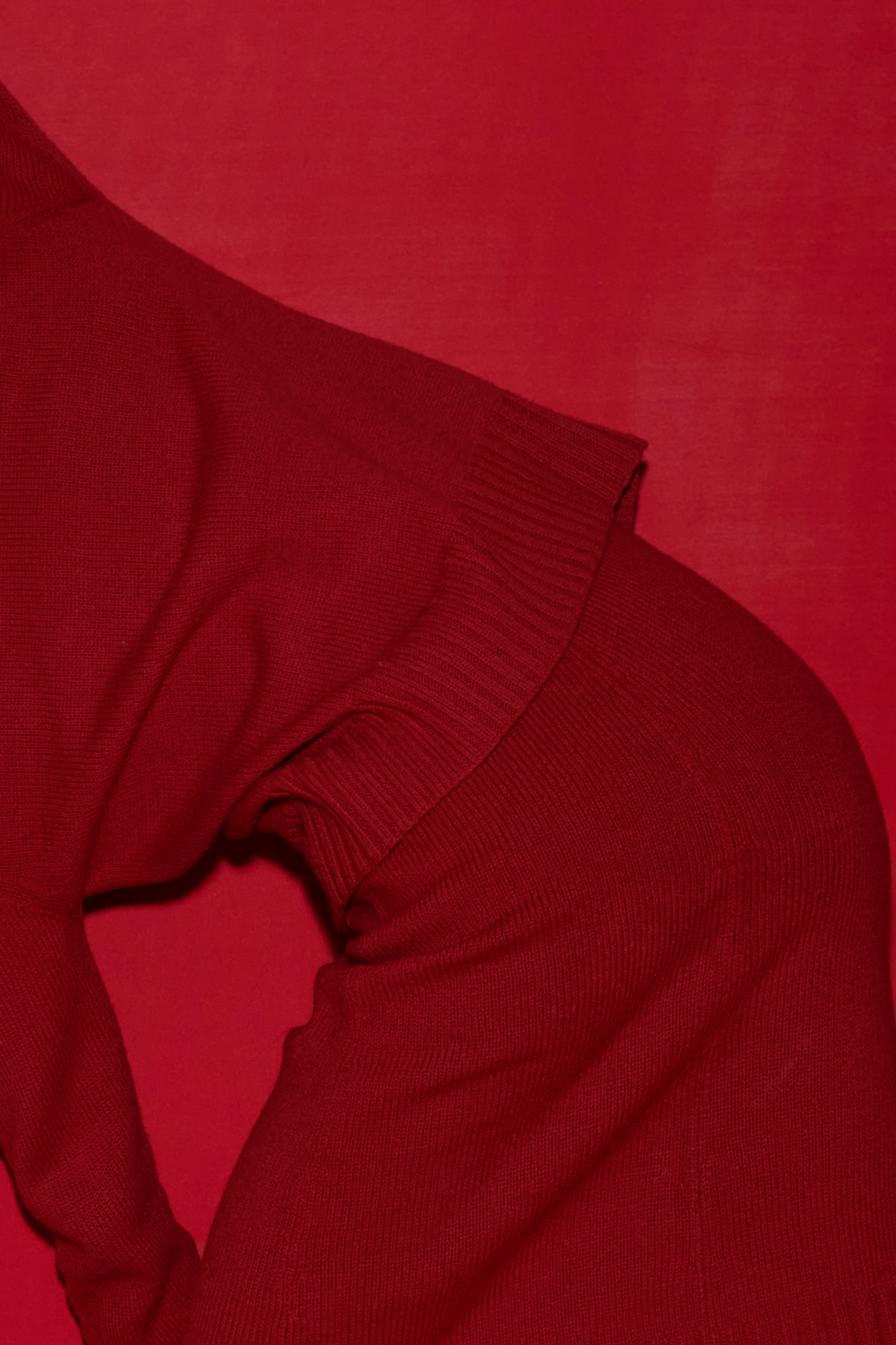 Matching red classic hat, top and skirt against a matching red background