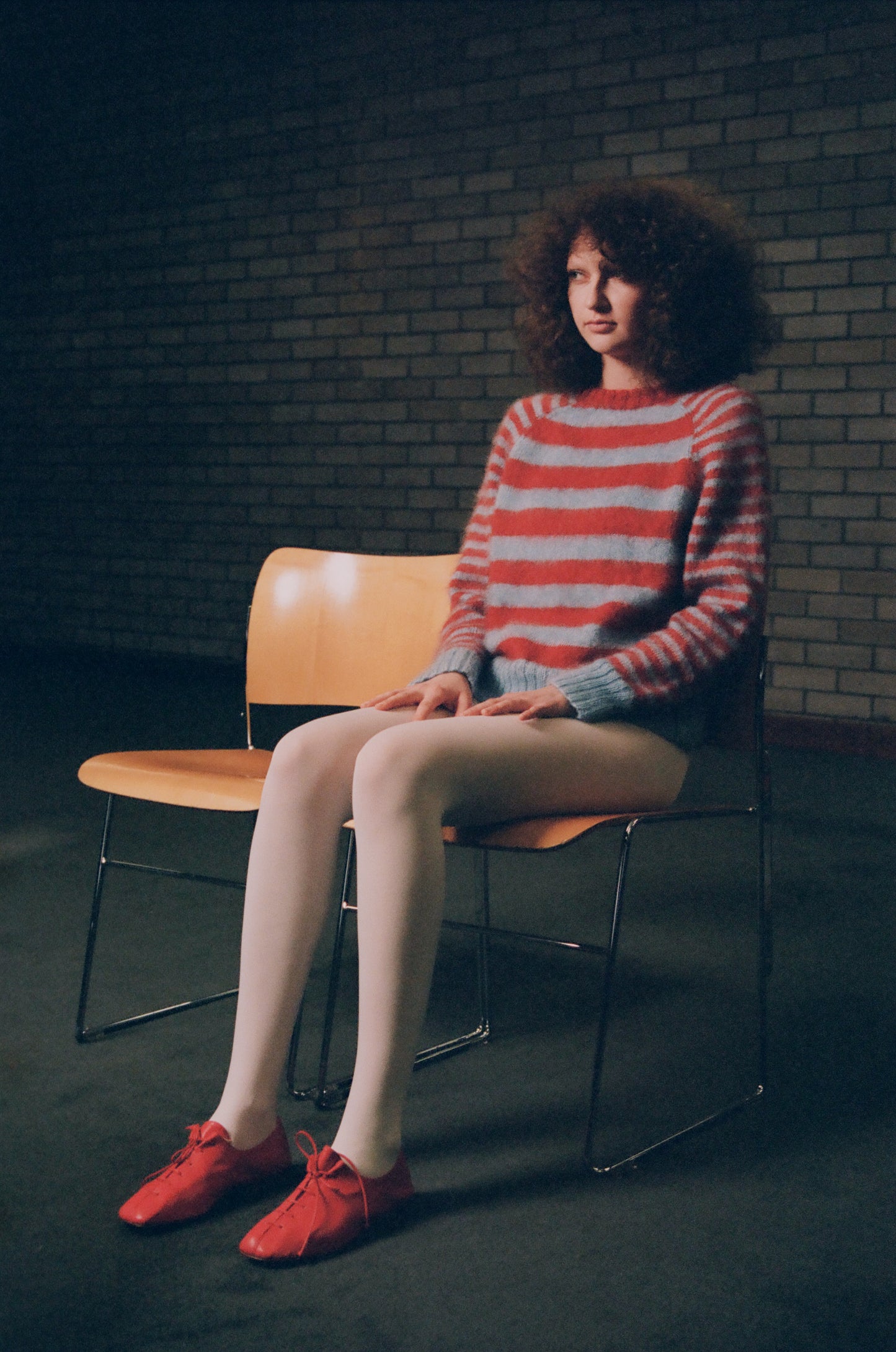 model wearing Mohair sweater in baby blue and  dark orange stripes