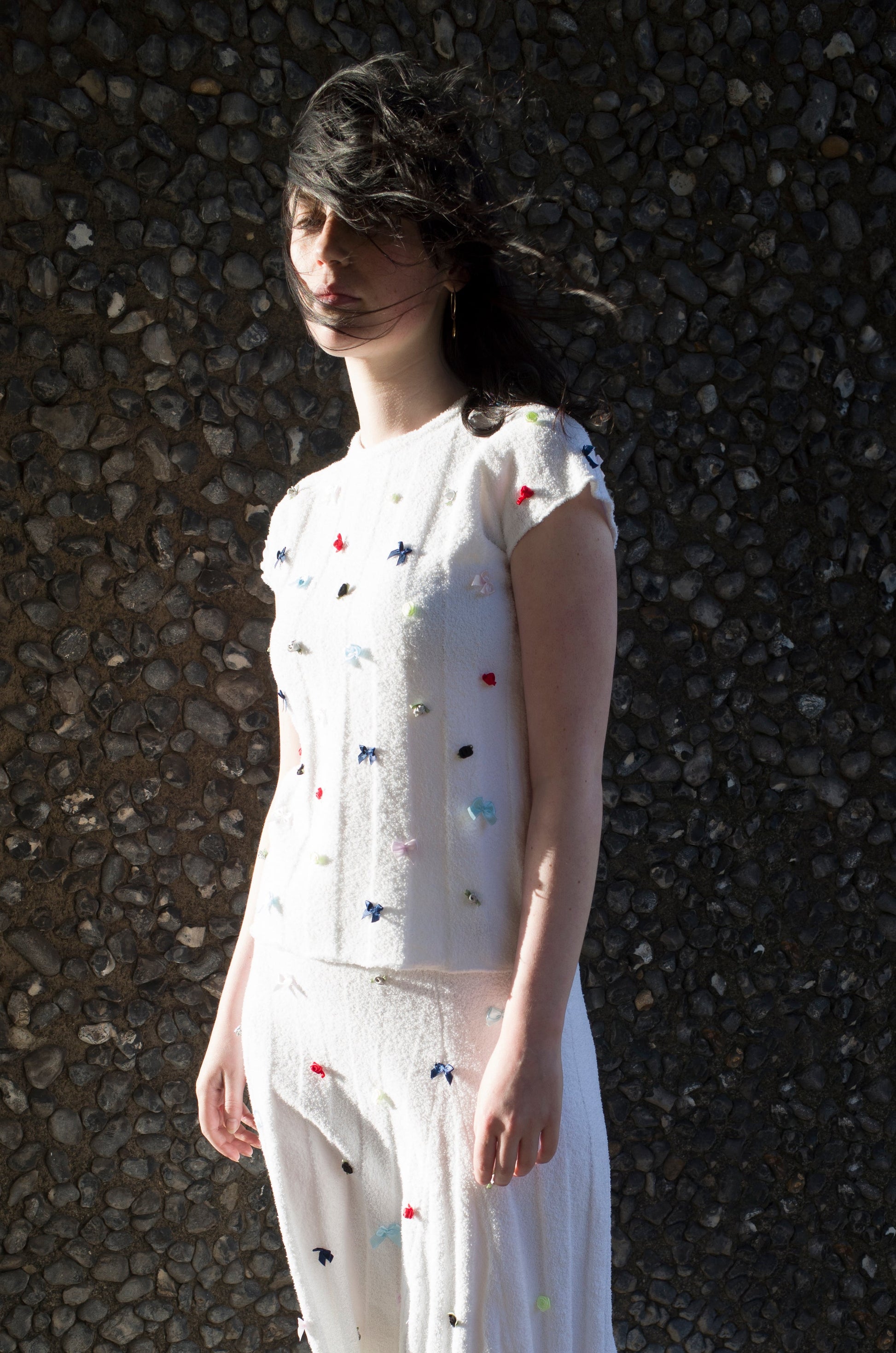 Model wearing flower top and skirt in white