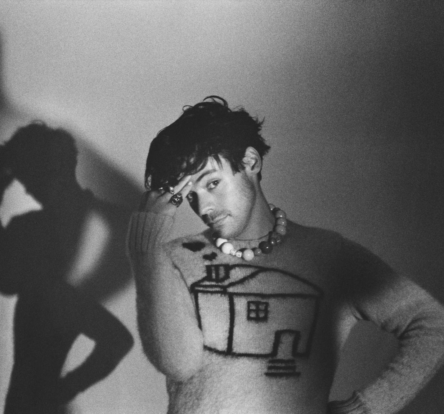 Harry Styles wearing custom mohair sweater with house motif by Ilana Blumberg