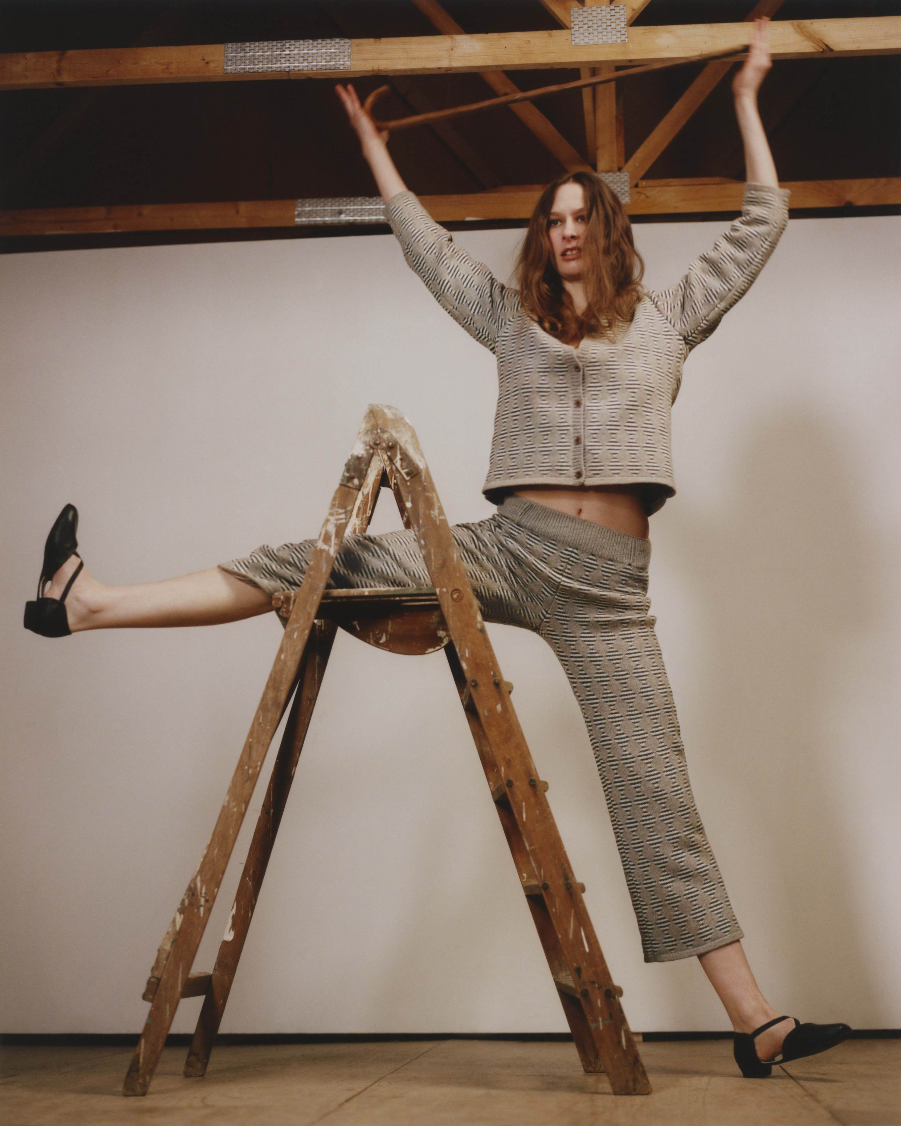 Model wearing matching set: cardigan and knitted trousers in diamond and stripes pattern