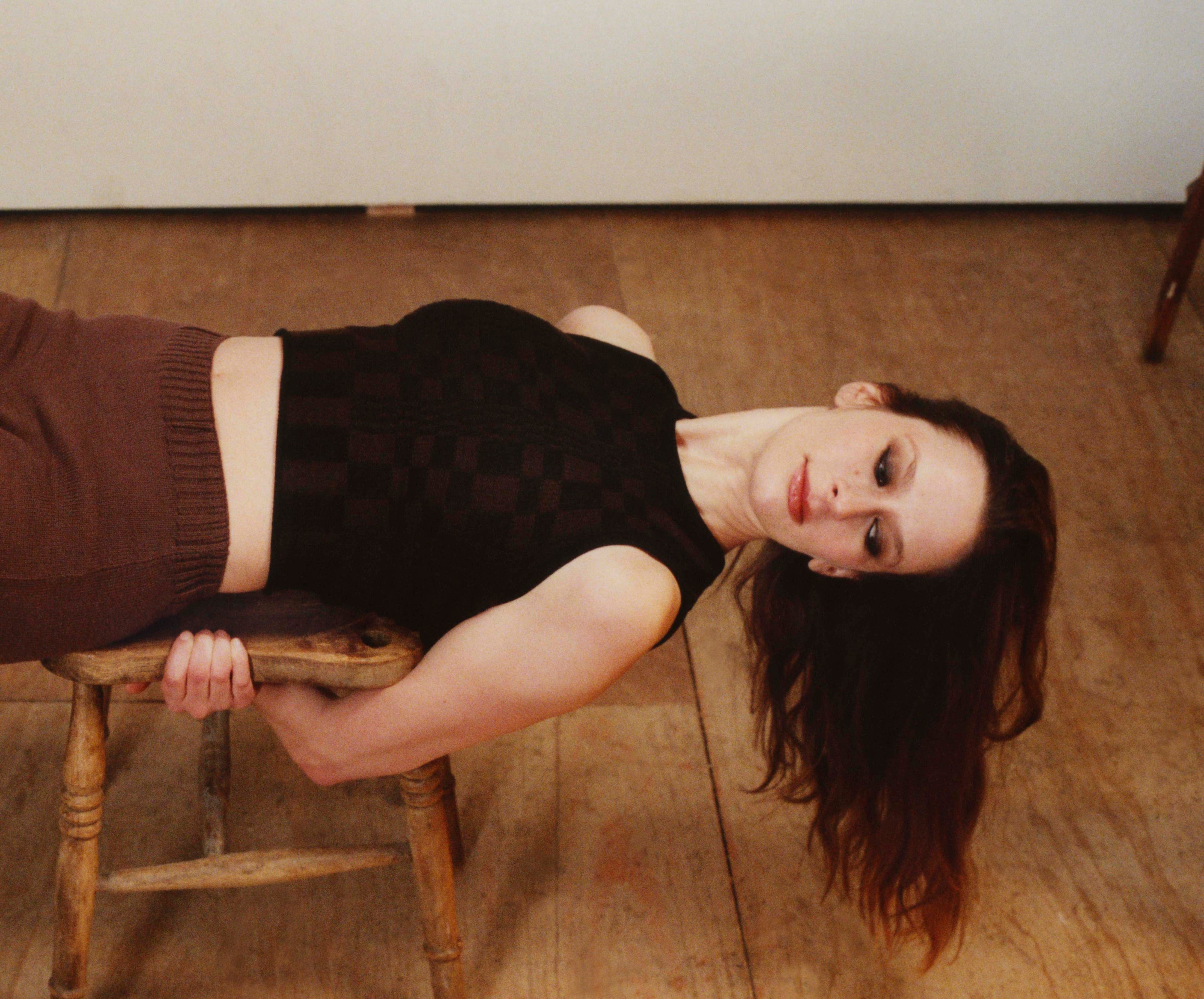 Model wearing black & brown vest and knitted brown trousers