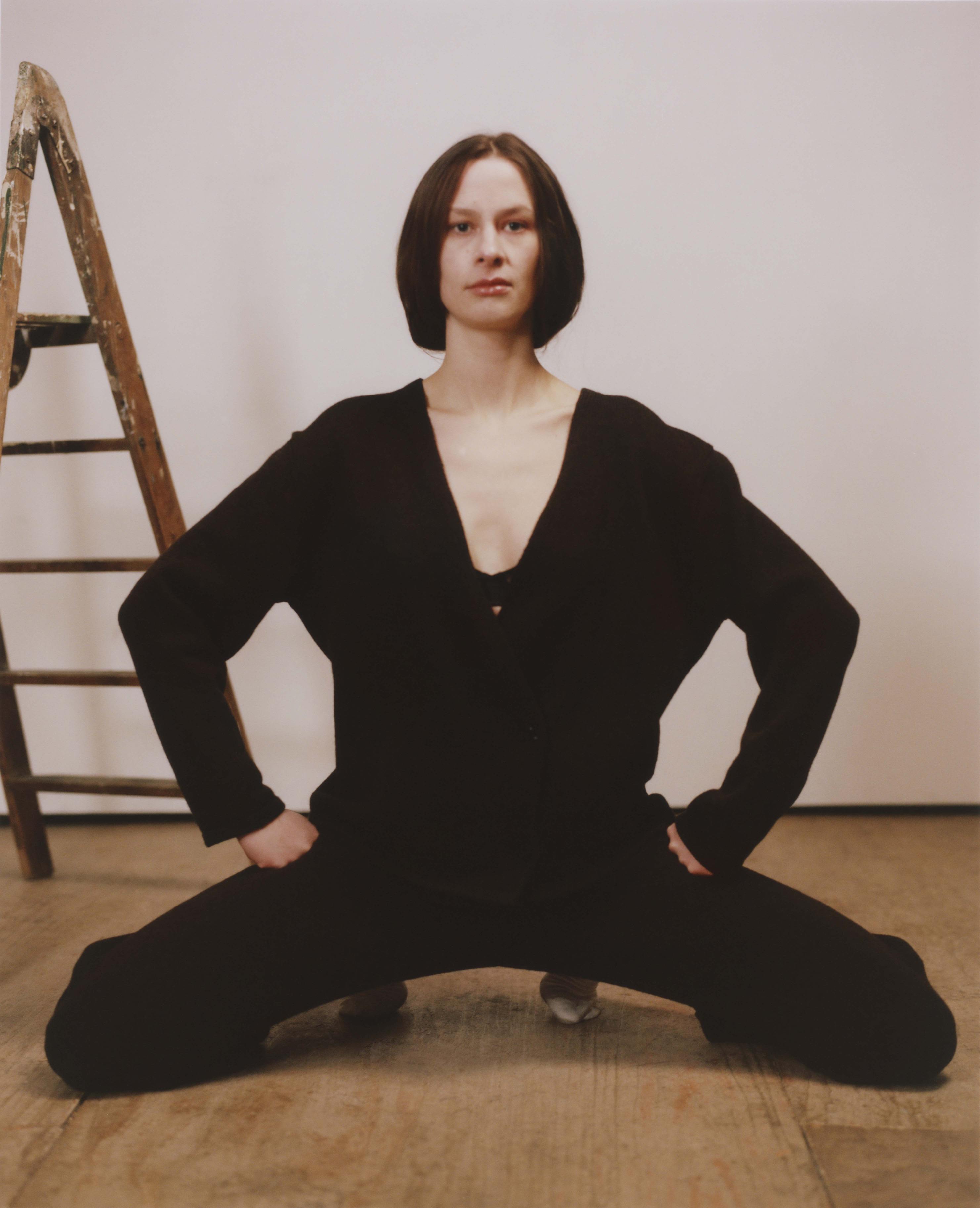 Model wearing matching black knitted cardigan and trousers