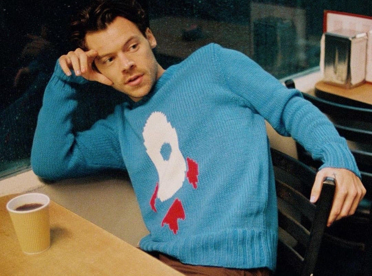 Harry Styles wearing custom sweater with rocket motif